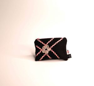 Black coin purse in quilted fabric with pink bands and a flower